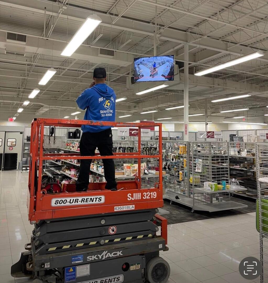 Pro Electrical technician on scissor lift performing commercial installation